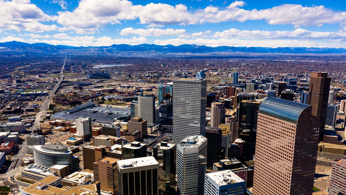 Denver skyline with the Rocky Mountains behind it