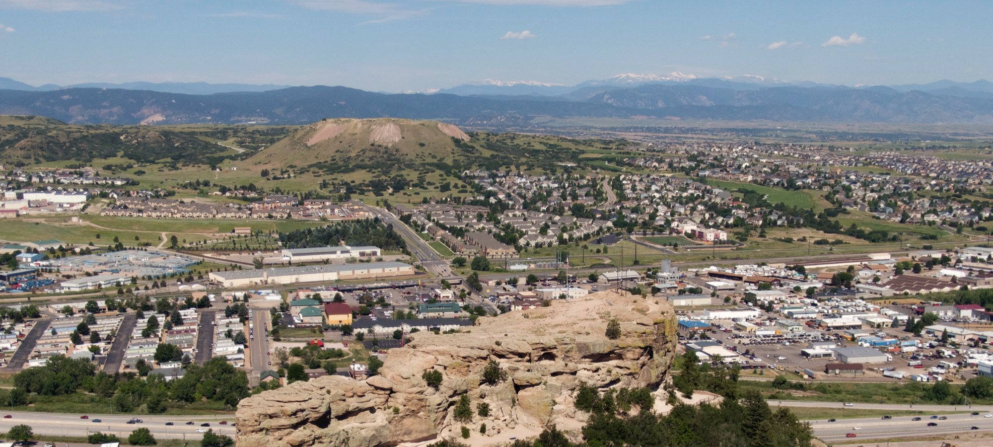 Aerial view of the Rock above Castle Rock, Colorado, with the Front Range mountains behind it