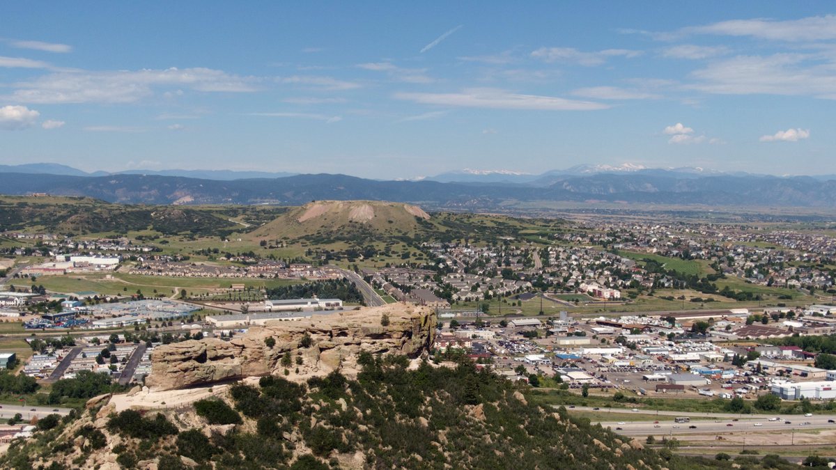 Aerial view of Castle Rock, Colorado, with the Rock and the Front Range mountains.